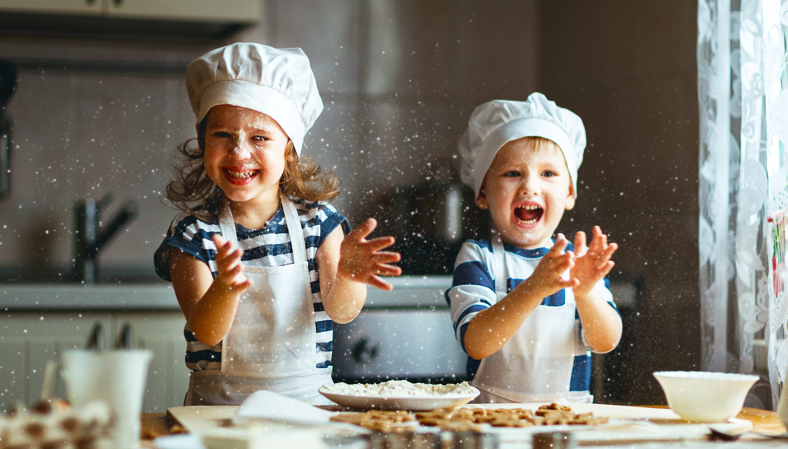 Image of happy kids preparing dough to bake cookies in the kitchen