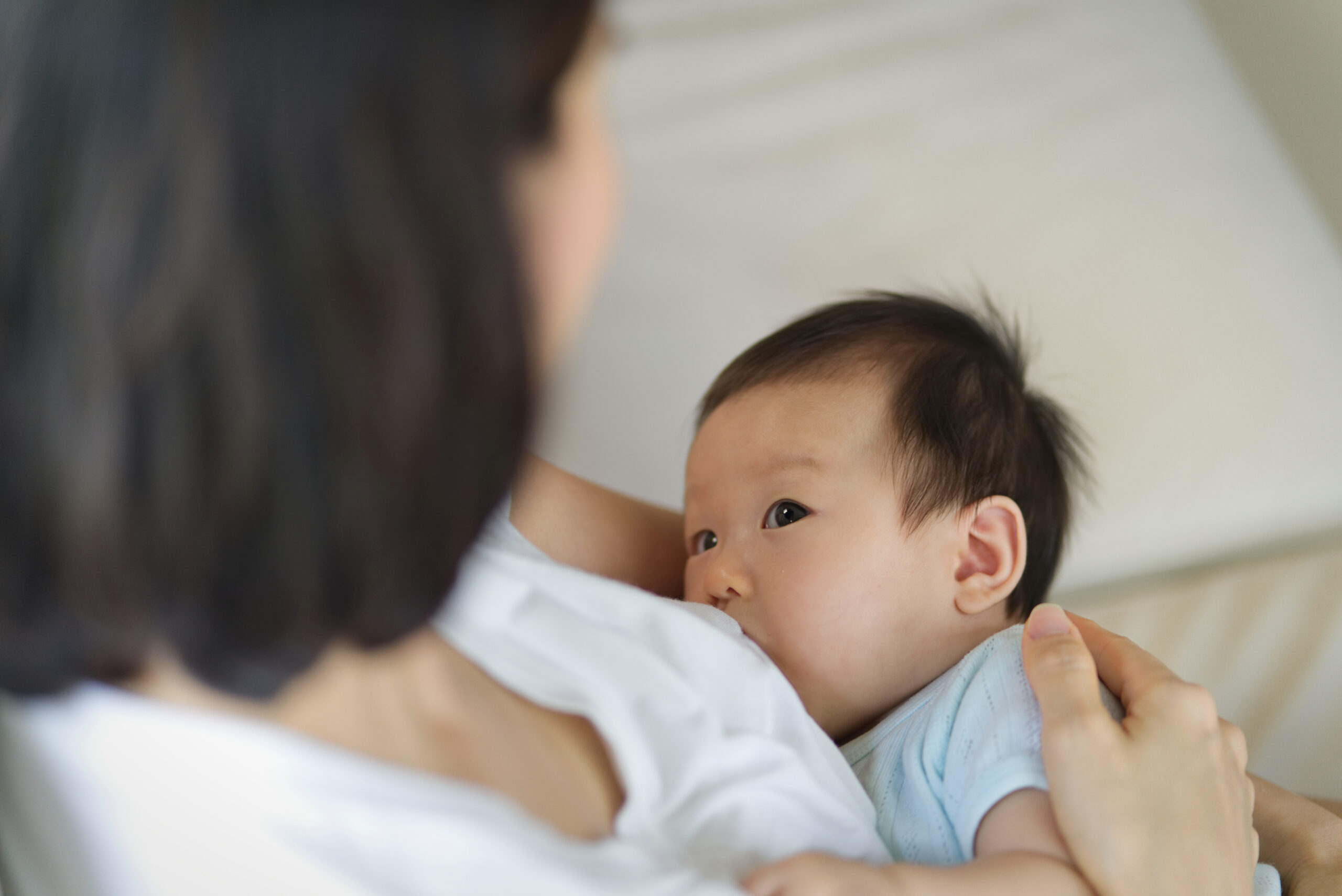 Image of a mother breastfeeding her infant which can promote preferences for healthy foods