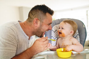 dad feeding baby solids foods