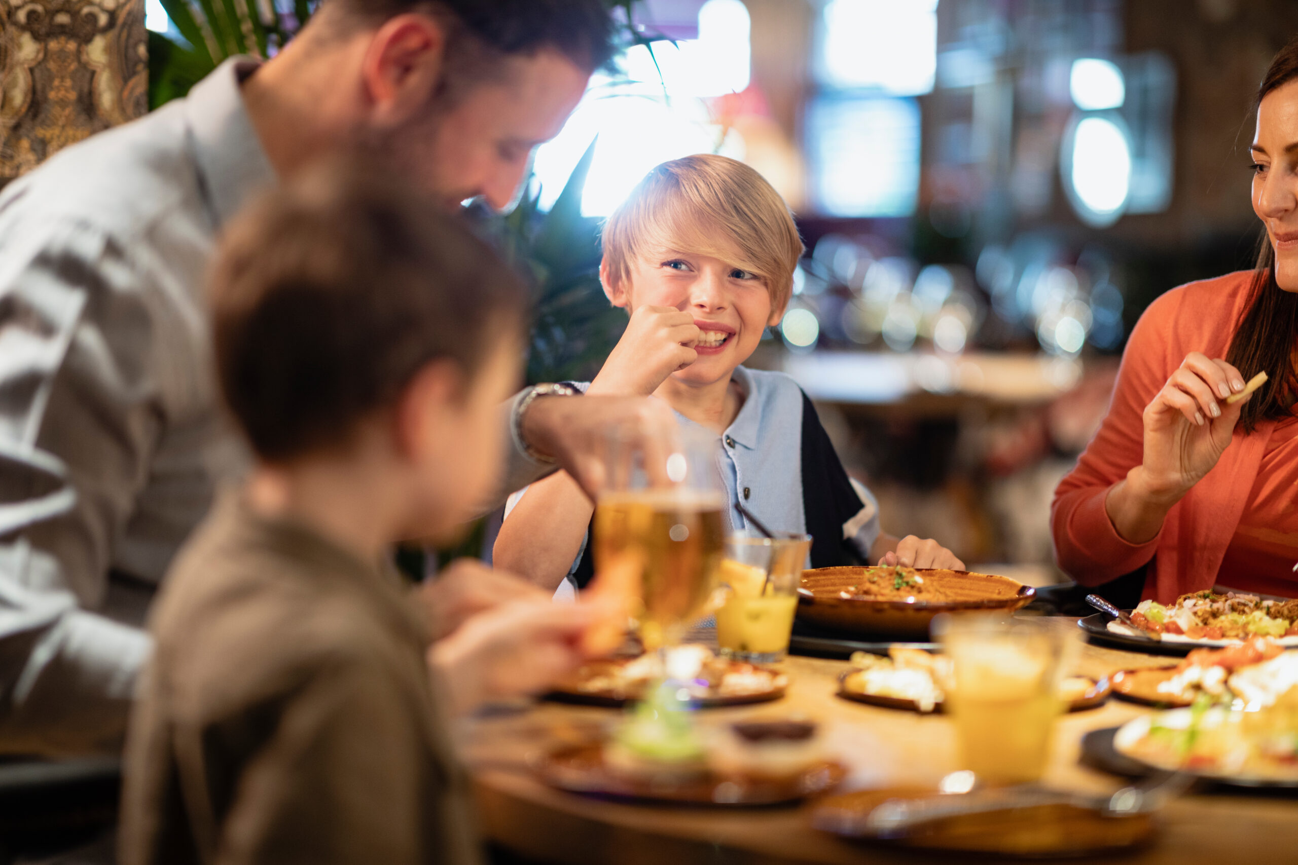 Image of a family having a meal together in a restaurant.