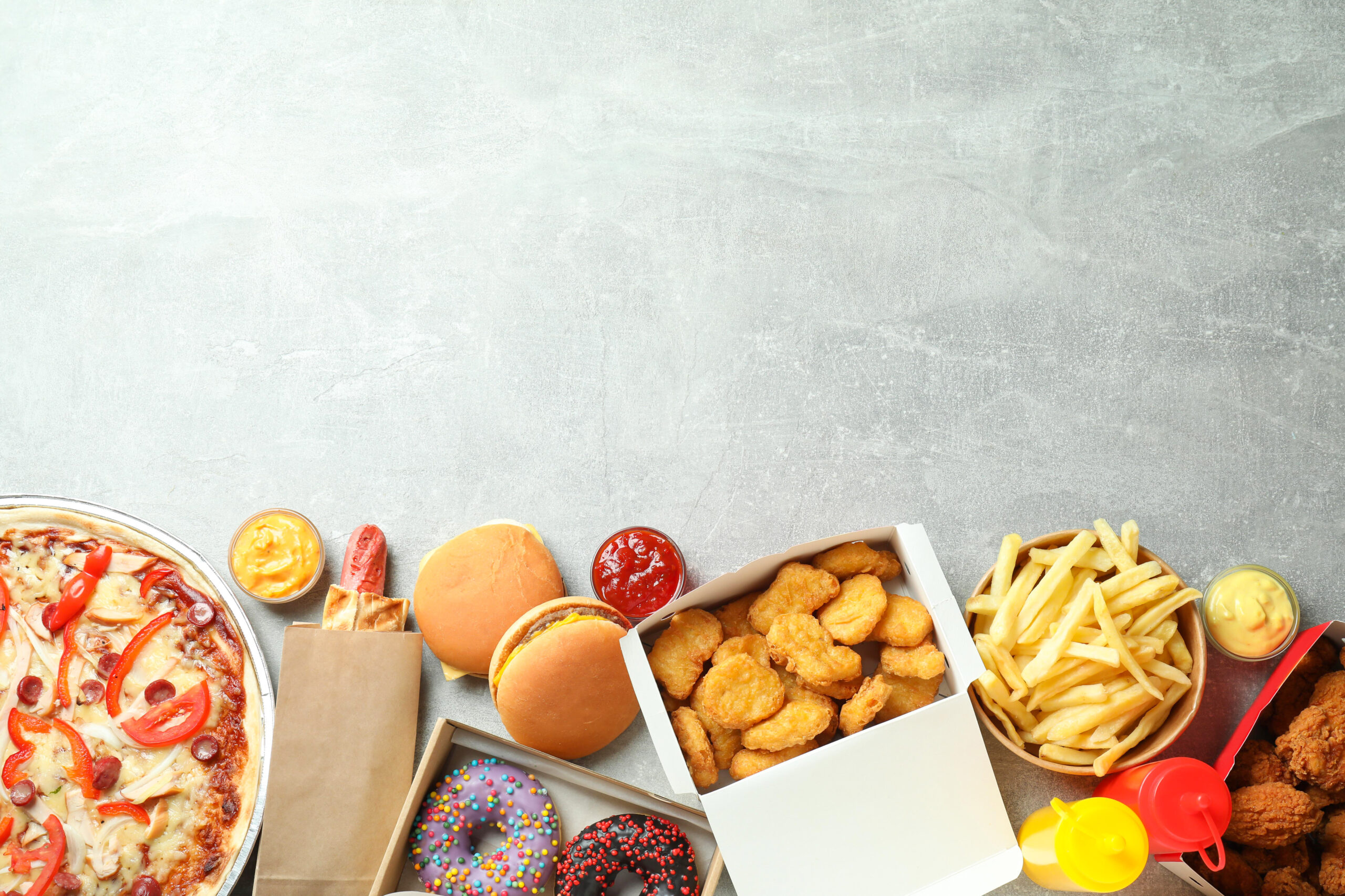 image of Different fast food on gray textured table