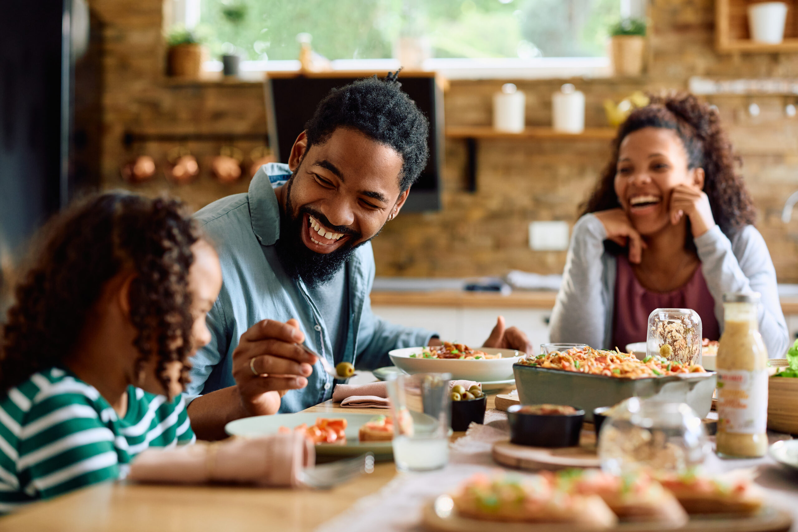 happy family enjoying a dinner together and laughing